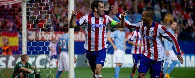 Captain Diego Godin celebrates scoring Atletico Madrid's fourth goal against Malmo with teammate Joao Miranda