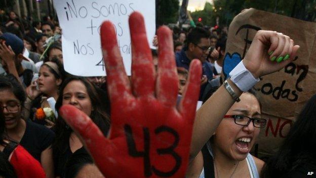 Demonstrators march in protest against the disappearance of 43 students from the Isidro Burgos rural teachers college in Mexico City on 22 October, 2014