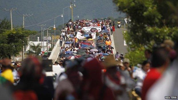 People participate in a demonstration to demand information on the 43 missing students in Iguala on 22 October, 2014.