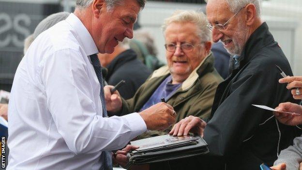 Sam Allardyce signs autographs outside Upton Park