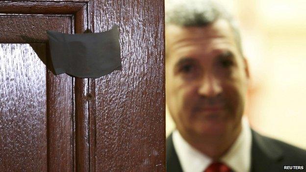 Bullet holes are pictured in the door leading to caucus meetings on Parliament Hill in Ottawa on 23 October 2014