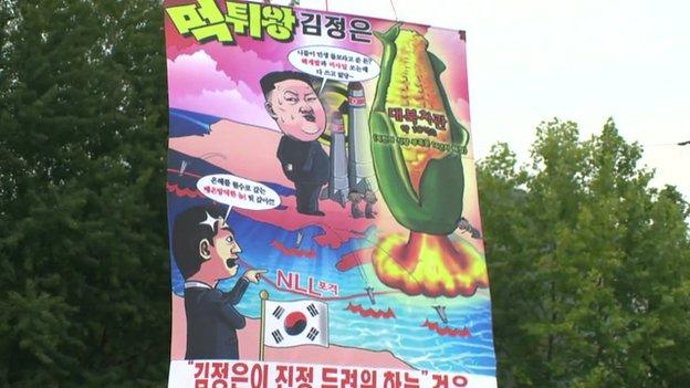 Still of poster mocking Kim Jong-un