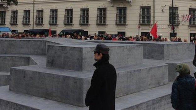 Onlookers walk around Austria's memorial to WW2 deserters