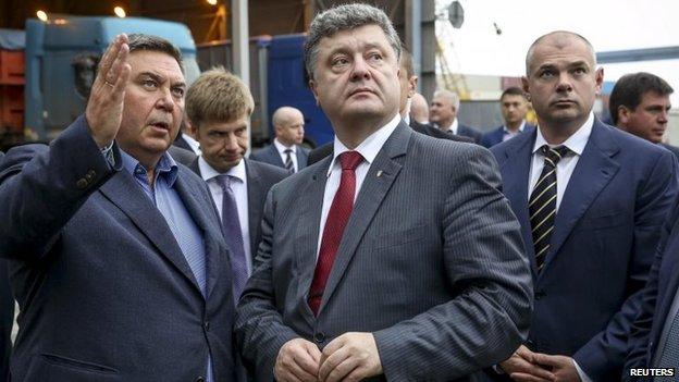 Ukraine's President Petro Poroshenko (C) visits a port in Odessa, Ukraine on 23 October 2014