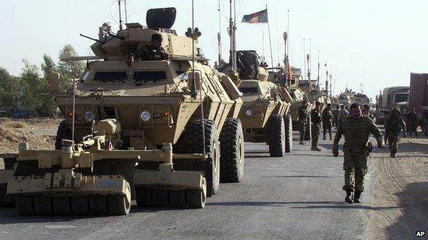 Afghanistan's National Army soldiers walk beside their vehicles on the outskirts of Lashkar Gah, the capital of Helmand province, Afghanistan, 18 October 2014