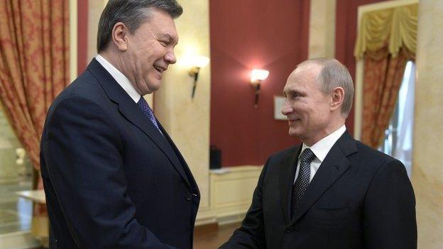 Russia's President Vladimir Putin (right) shakes hands with Viktor Yanukovych in February 2014