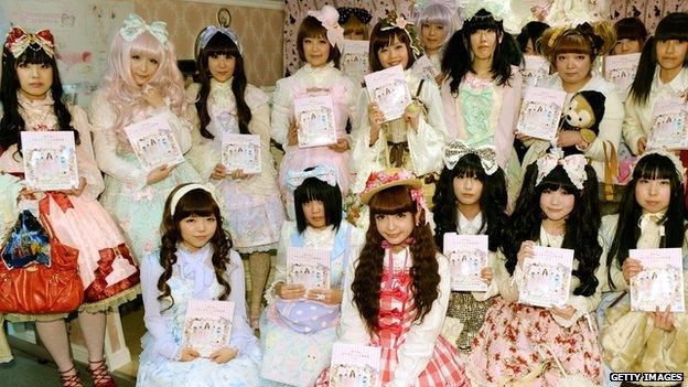 Fans dressed in gothic-inspired 'Lolita' outfits pose with Japan's Lolita-style fashion leader Misako Aoko