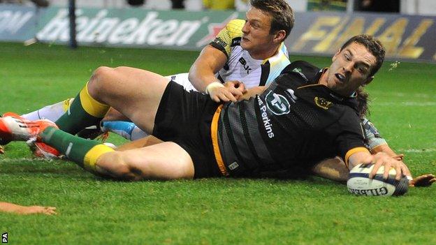 Northampton winger George North beats Ospreys' fly-half Dan Biggar, among others, to score his fourth try