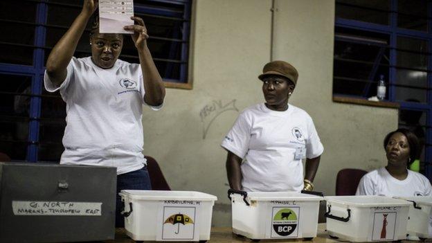 Polling officers count ballot boxes at a counting centre in Gaborone on 24 October 2014 during the Botswana general elections.