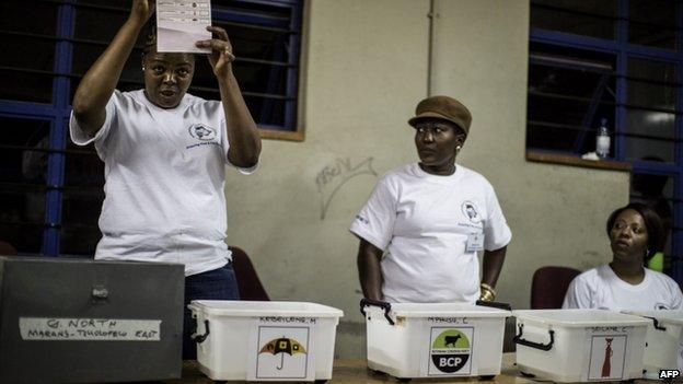 Polling officers count ballot boxes at a counting centre in Gaborone on 24 October 2014 during the Botswana general elections.