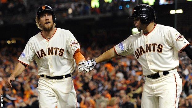 Hunter Pence (left) celebrates after scoring a run for San Francisco Giants