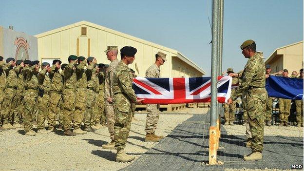 Troops fold a union flag