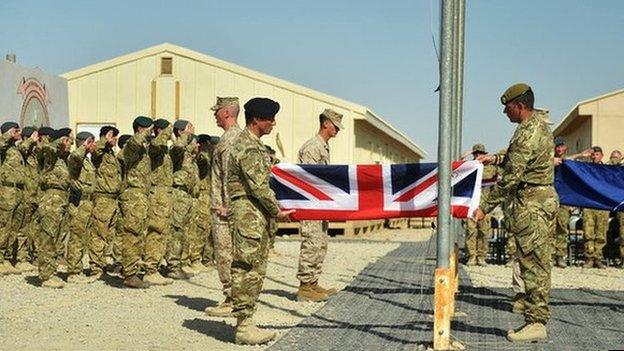 Troops fold a union flag