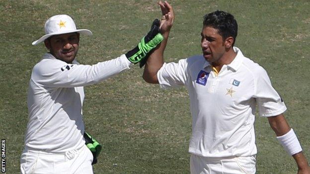 Pakistan's Sarfraz Ahmed and Imran Khan celebrate the dismissal of Australia's Chris Rogers