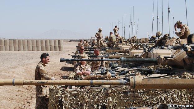 Soldiers preparing their weaponry before leaving Camp Bastion.