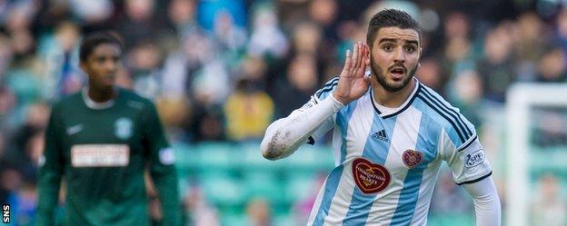 Alim Ozturk celebrates after scoring for Hearts against Hibernian