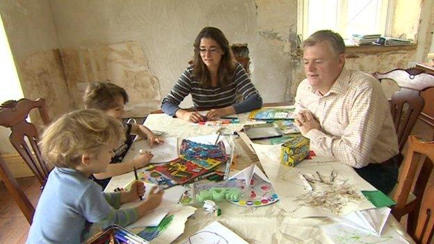 Rod McDonagh with his wife Jo and two sons in their home in Muchelney