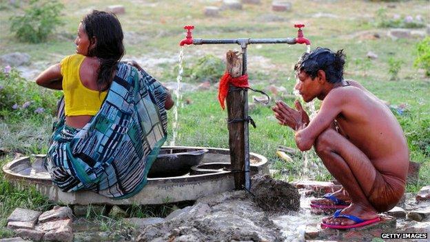 Girl and boy washing in India