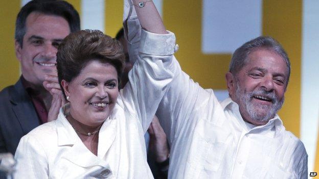 Dilma Rousseff celebrates with Brazil's former President Luiz Inacio Lula da Silva at a news conference in Brasilia, Brazil, Sunday, October 26, 2014