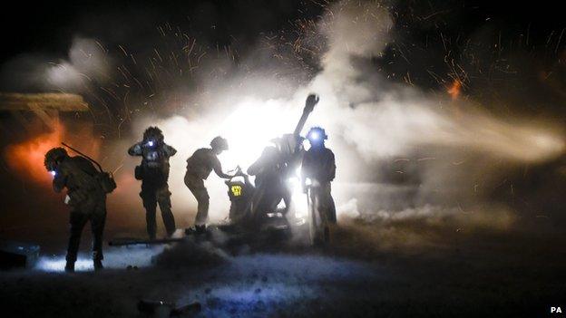 Royal Artillery 105mm light gun crew fire out and over the perimeter of Camp Bastion on 25 October 2014, on their last fire mission to deter Taliban around the base