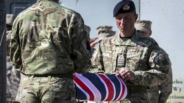 Two British soldiers hold a union jack