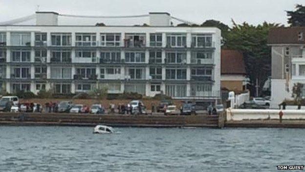 Car in the water at Sandbanks