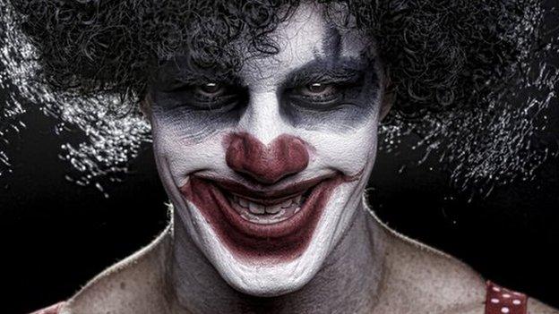 Evil clown smiling