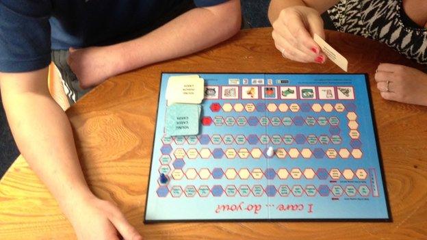 People playing the young carers' board game