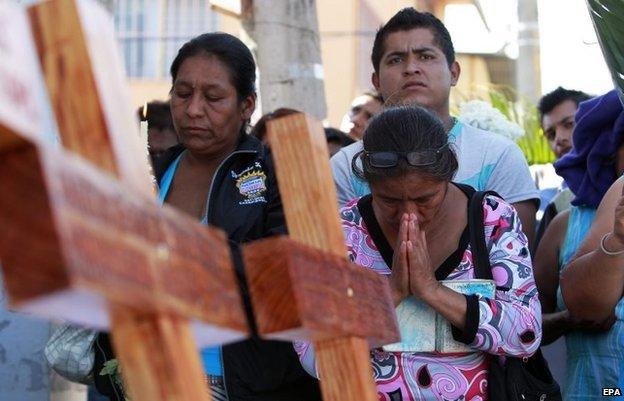 Relatives of the 43 missing students attend a mass at the same place where three students were killed on 26 September