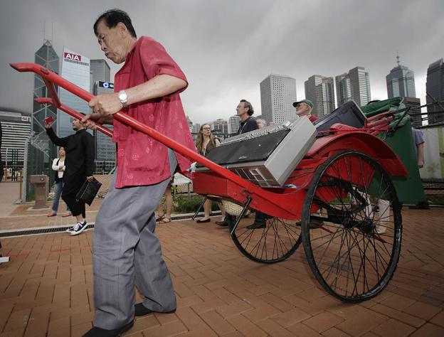 Man pulling rickshaw in Hong Kong