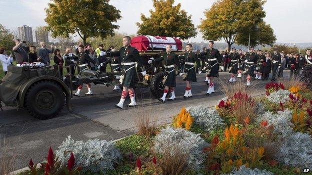 The coffin of Cpl Nathan Cirillo is towed on a gun carriage during his funeral procession in Hamilton, Ontario 28 October 2014