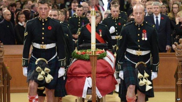 The casket of Cpl Nathan Cirillo is carried by pallbearers at his regimental funeral service in Hamilton, Ontario 28 October 2014