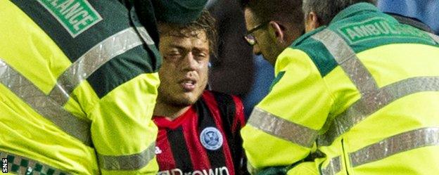 St Johnstone midfielder Murray Davidson is treated for an eye injury