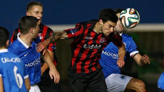 Declan Caddell heads one of his two Crusaders goals in the 4-2 win over holders Linfield