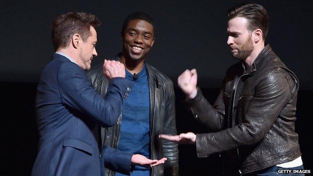 Robert Downey Jr (left) with Captain America co-stars Chris Evans (right) and Chadwick Boseman