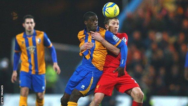 Athony Howell (centre) tussles with Liverpool's Lucas Leiva