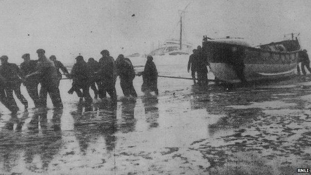 The lifeboat being dragged across the rocks in an attempt to reach the Rohilla