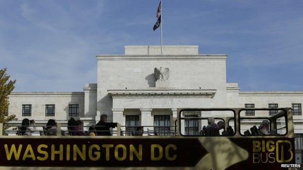 A tour bus passes the United States Federal Reserve Board building in Washington