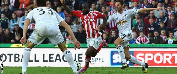 Victor Moses of Stoke is challenge by Swansea's Angel Rangel, who conceded a penalty.