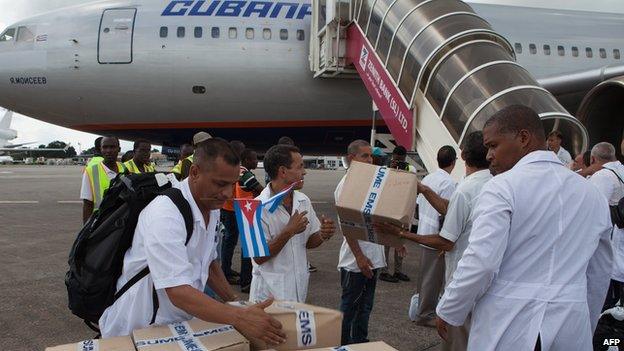 The first members of a team of 165 Cuban doctors and health workers upon their arrival at Freetown's airport to help the fight against Ebola in Sierra Leone, on October 2, 2014.