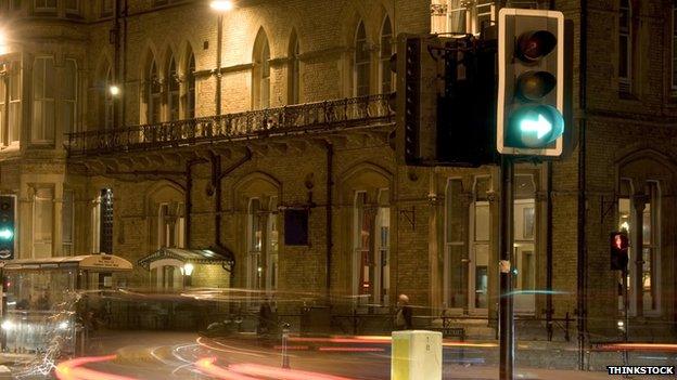 Street scene at night with traffic lights