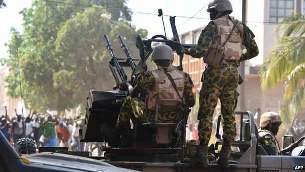 Burkina Faso troops try to disperse protesters in Ouagadougou on 30 October 2014