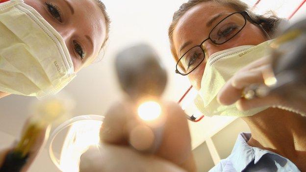 Two dentists wearing masks