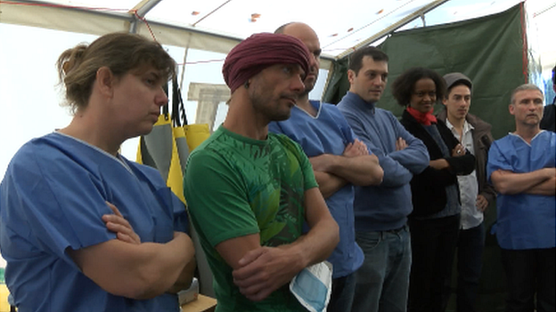 Volunteers at the Red Cross centre watch a demonstration