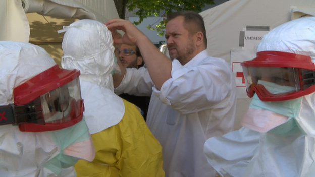 Volunteers at the Red Cross have the final touches applied to their medical kit