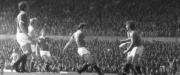 Denis Law (second from left) scores