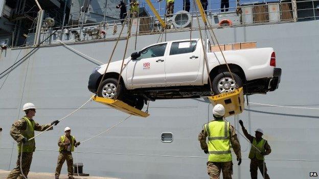 Pick-up trucks being offloaded from RFA Argus