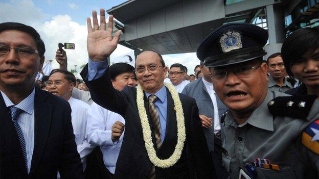 October 1, 2012, Myanmar President Thein Sein (C) greets supporters as he arrives at Yangon International Airport