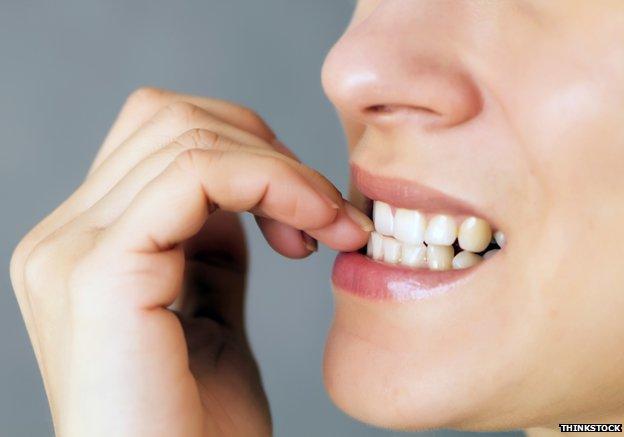 Woman biting nails