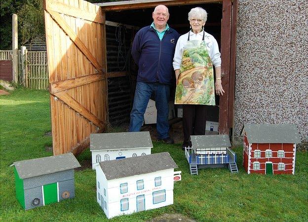 Beverley Lorking (left) and Pat Bullman in front of the restored model village buildings